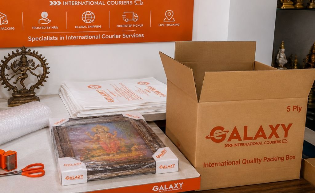Handicraft courier service in Chennai — artisan packing a brass statue and Tanjore painting into a double-wall carton for shipping